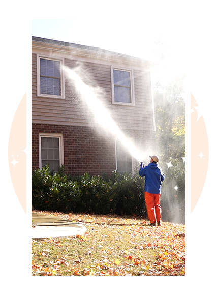 Professional house washing technician pressure washing the front of a residential home in Downingtown PA — safe, affordable, fully insured exterior cleaning service